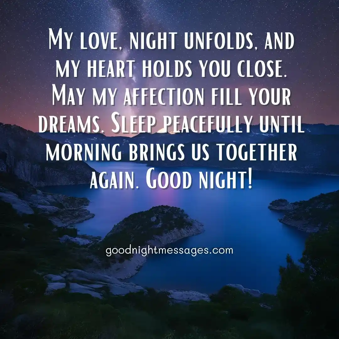 Good Night Message My Love: A romantic night landscape featuring a deep blue lake surrounded by dark mountains under a starry sky with the Milky Way visible, displaying the message My love, night unfolds, and my heart holds you close. May my affection fill your dreams. Sleep peacefully until morning brings us together again. Good Night!